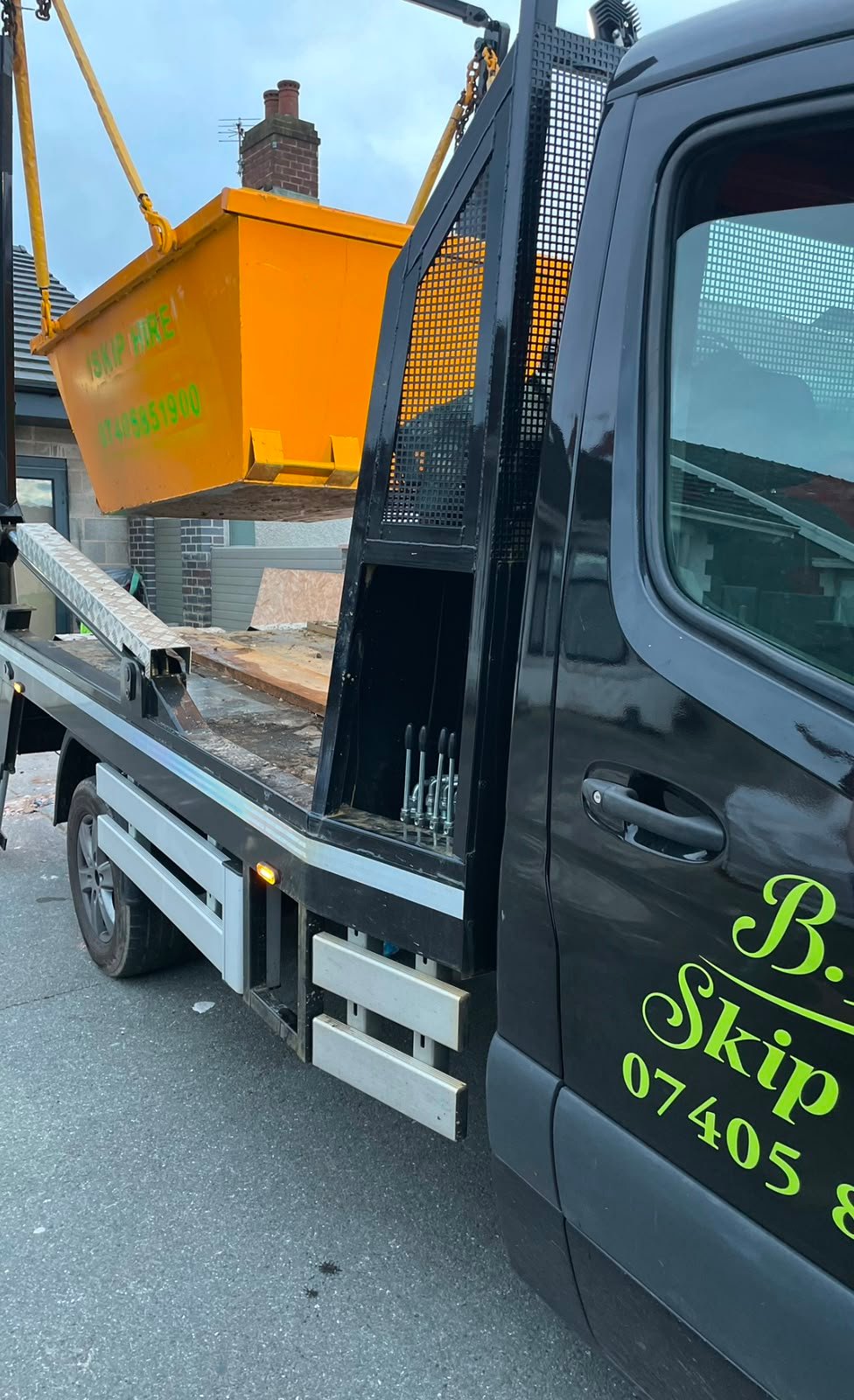 BIS Skip Hire truck loading a skip in Lancashire